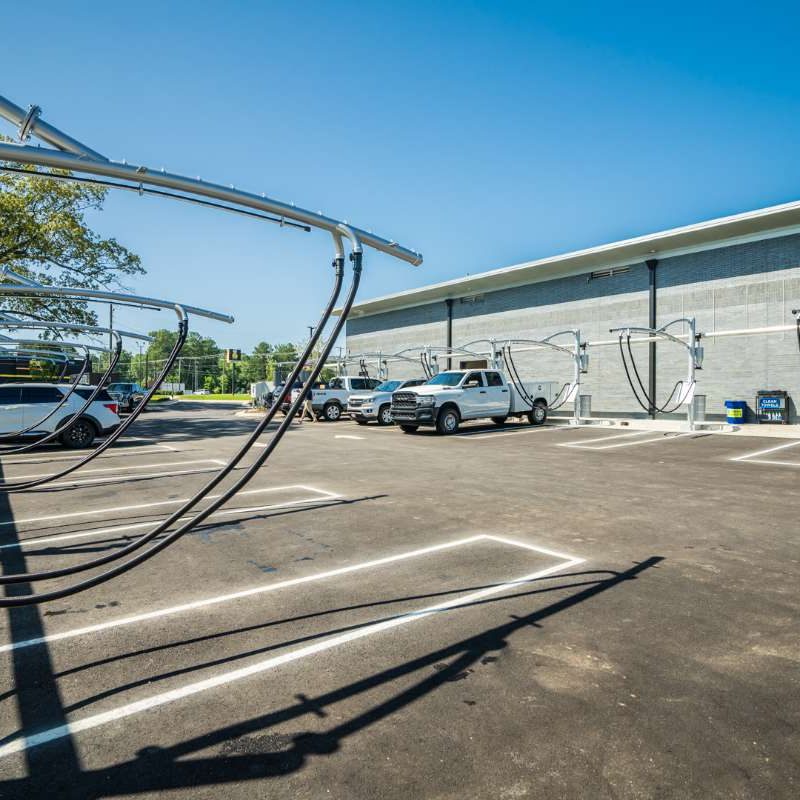 Vehicles parked at vacuuming stations in Splash Car Wash parking lot.