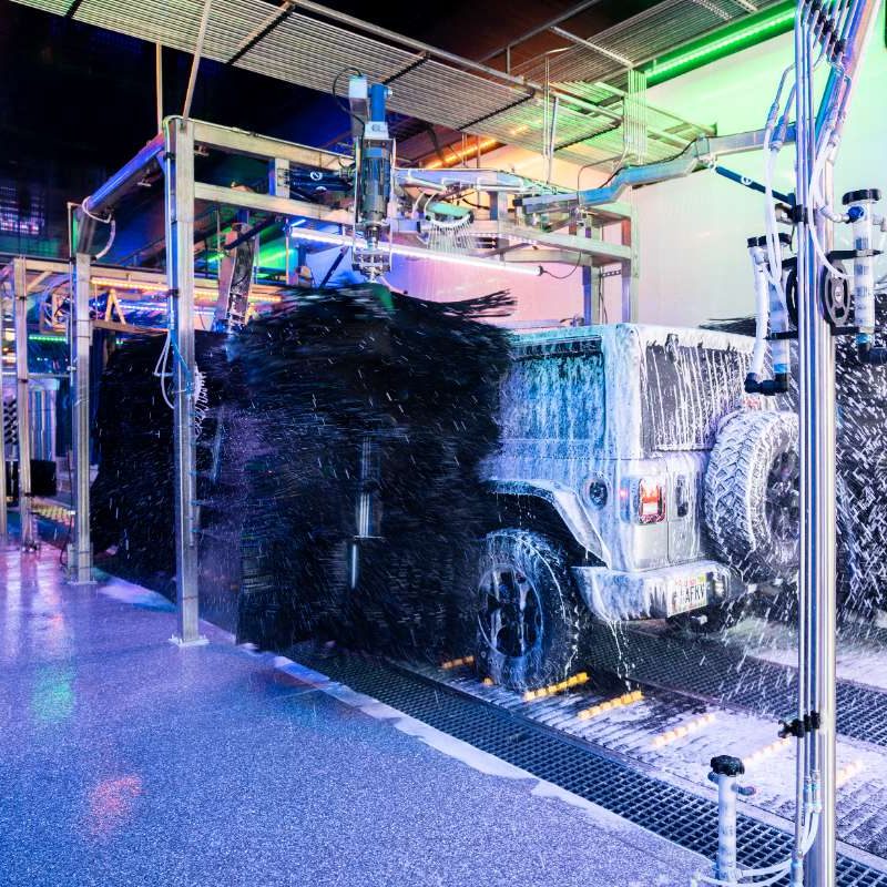 Jeep goes through the Splash Car Wash, being cleaned with soap and water.