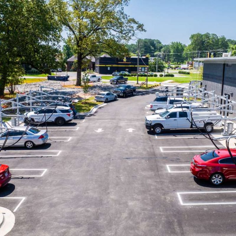 Vehicles are parked in nearly every vacuuming station outside of Splash Car Wash building.