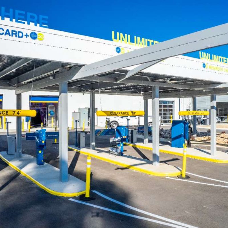 Entrance to Splash Car Wash West Little Rock location with two PAY HERE lanes and two UNLIMITED lanes, all separated by barriers.