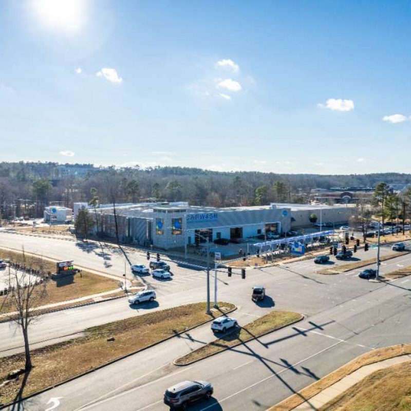 Aerial view of West Little Rock Splash Car Wash facility. Building surrounded by highways with outside vacuuming stations.